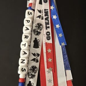 Custom school swag keychain with red, blue and white ribbons, decorative beads and SPARTANS letter beads.